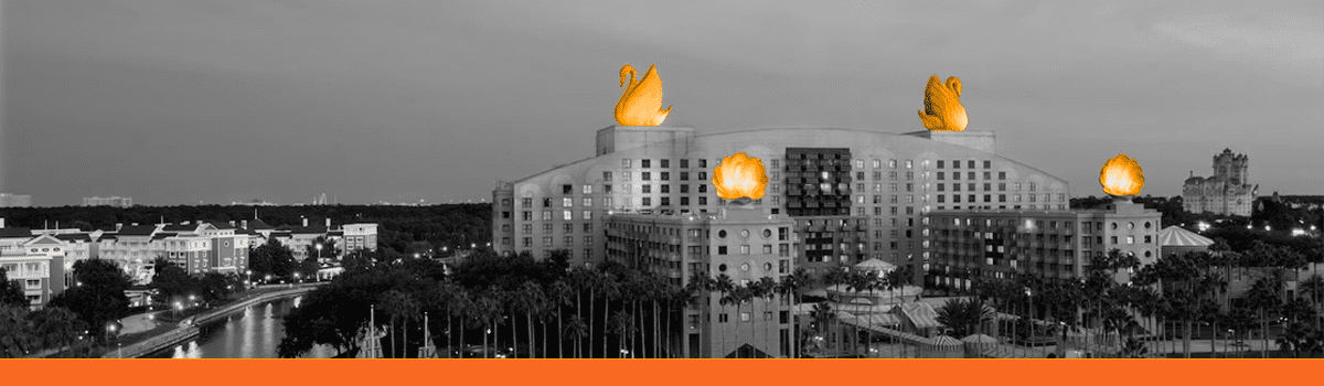 A black and white image of a building with orange swans on top