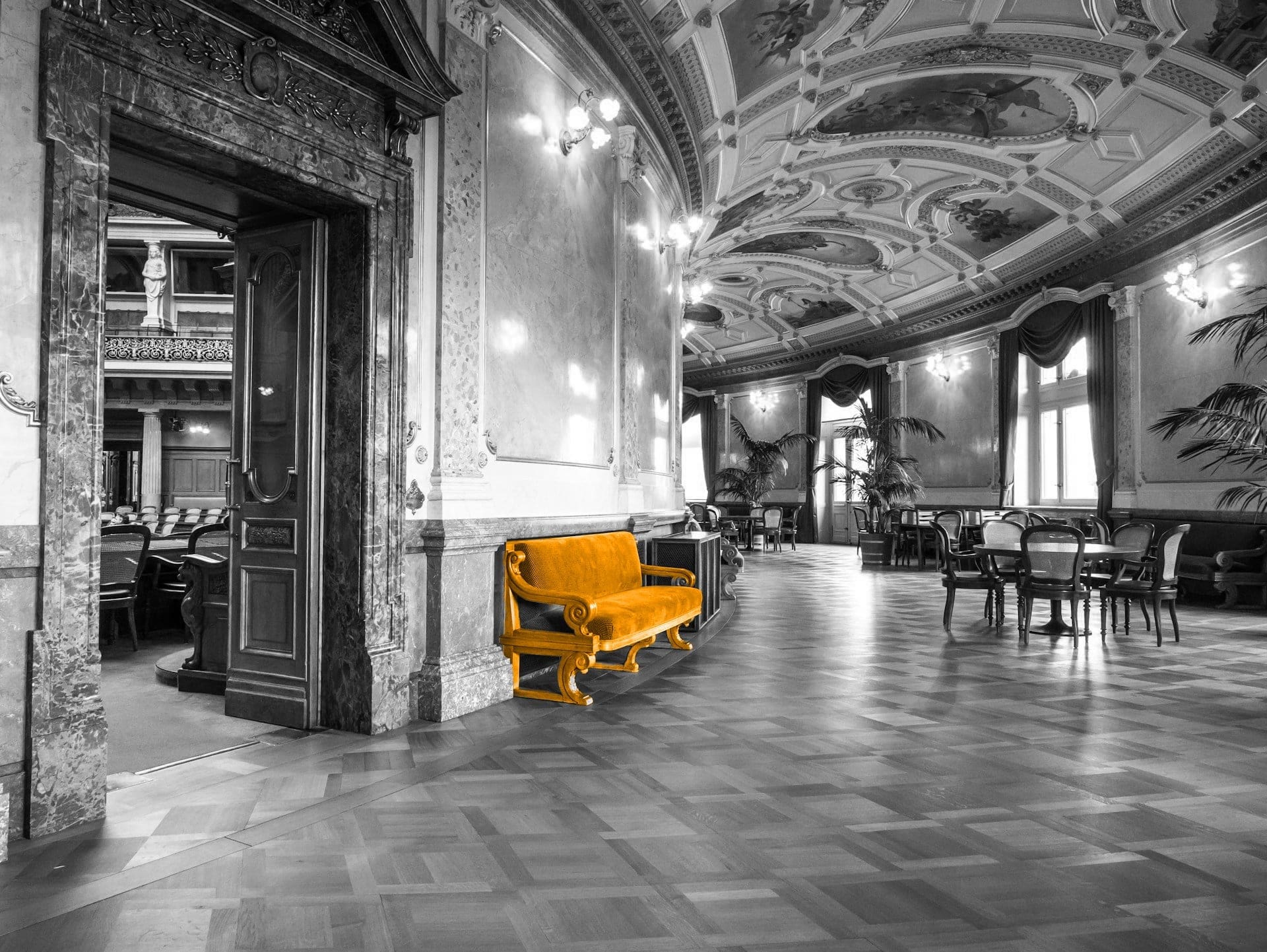 A black and white image of a governmental building with a orange chair