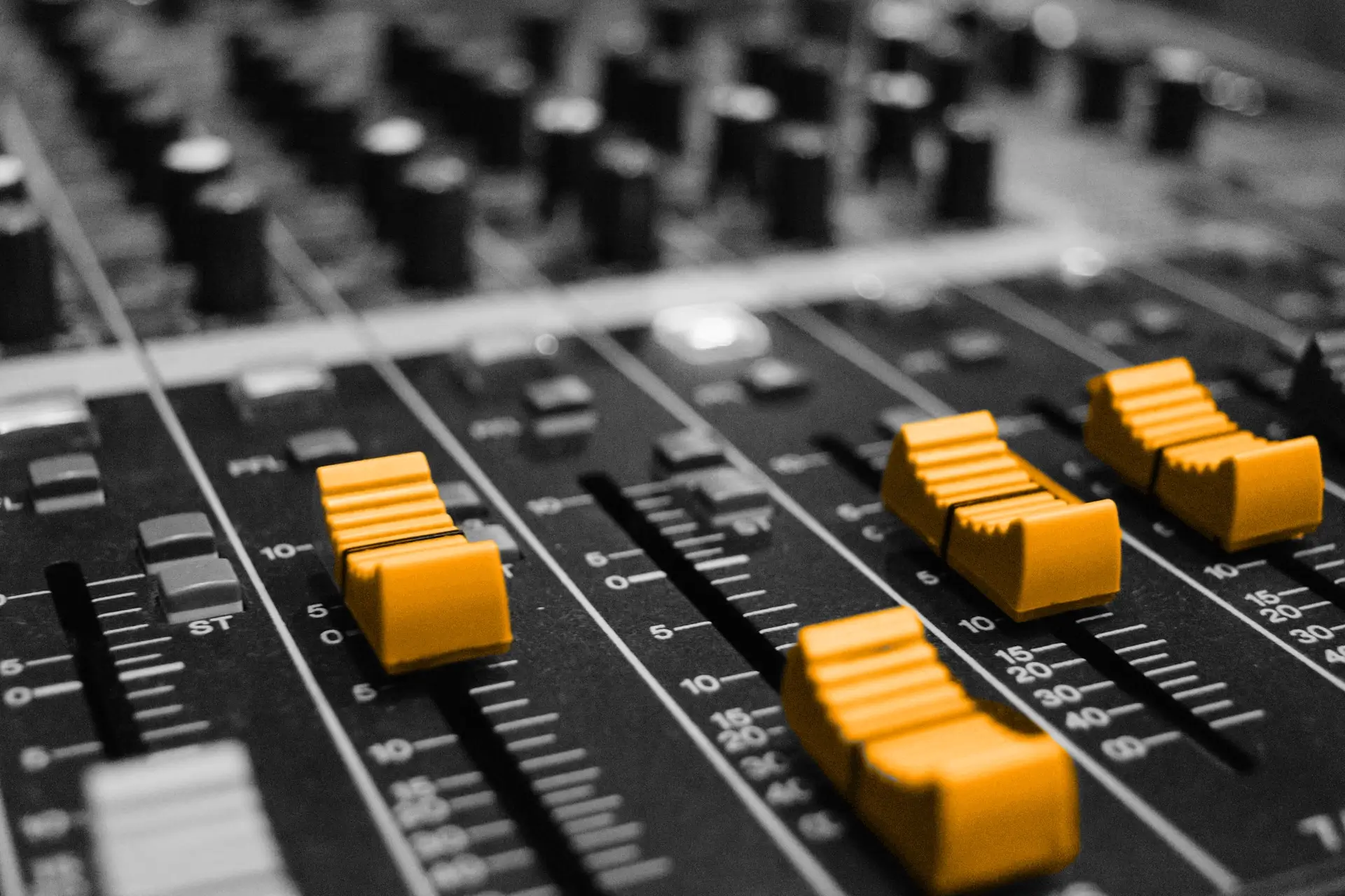 A black and white piece of music equipment with orange dials