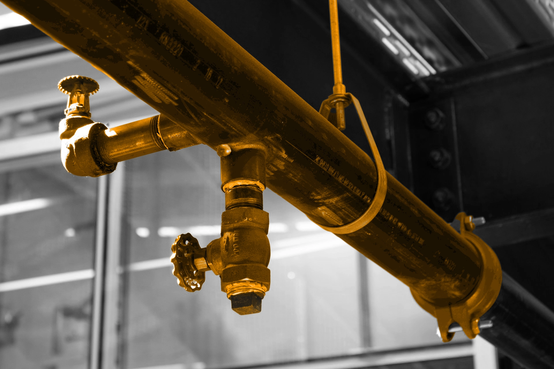 A black and white background with an orange gas pipe in the foreground